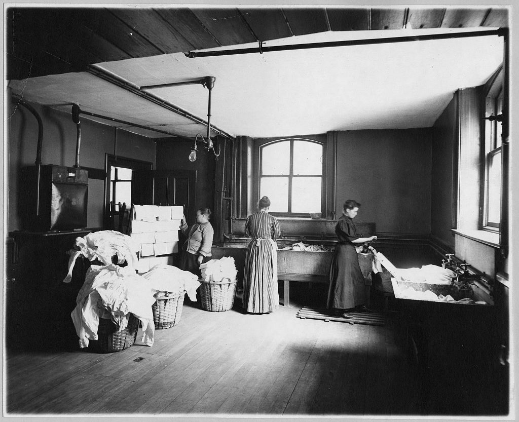 Women wash and hang clothes (see the rack at the left) in Boston